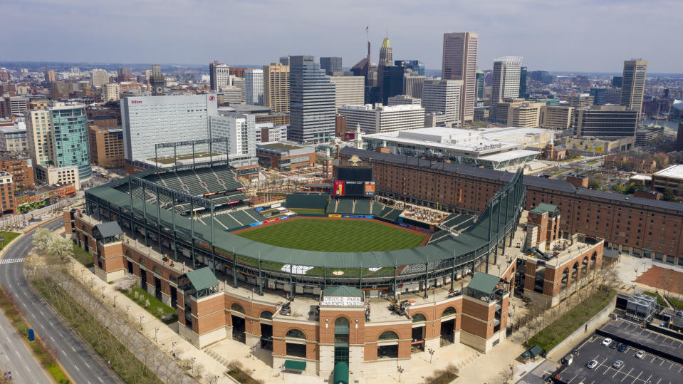 In this aerial photo, Oriole Park at Camden Yards is closed on what would've been Opening Day, Thursday March 26, 2020, in Baltimore, Md. The Orioles were slated to host the New York Yankees at the park, but the season has been delayed due to the coronavirus outbreak. (AP Photo/Steve Helber)