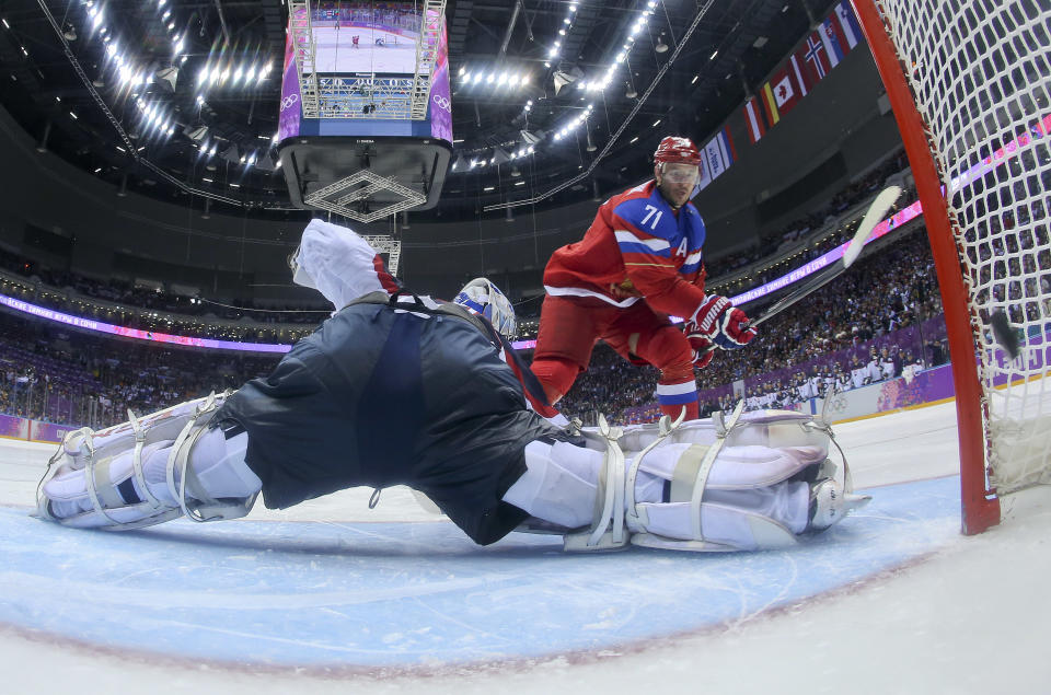 Russia forward Ilya Kovalchuk flips the puck past Slovakia goaltender Jan Laco to score in a shootout during overtime of a men's ice hockey game at the 2014 Winter Olympics, Sunday Feb. 16, 2014, in Sochi, Russia. The shot gave Russia a 1-0 win. (AP Photo/Bruce Bennett, Pool)