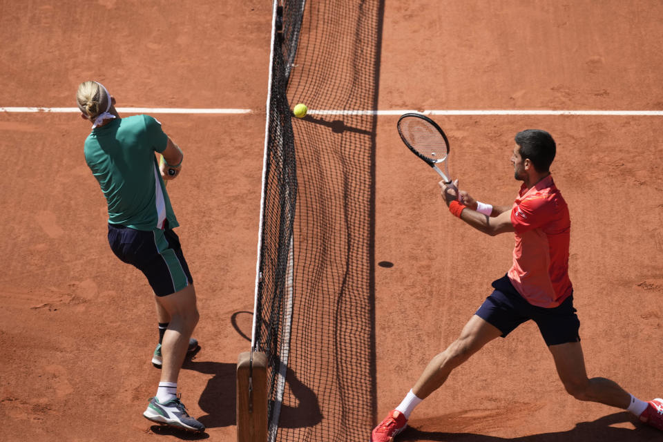 Serbia's Novak Djokovic, right, plays a shot against Spain's Alejandro Davidovich Fokina during their third round match of the French Open tennis tournament at the Roland Garros stadium in Paris, Friday, June 2, 2023. (AP Photo/Christophe Ena)