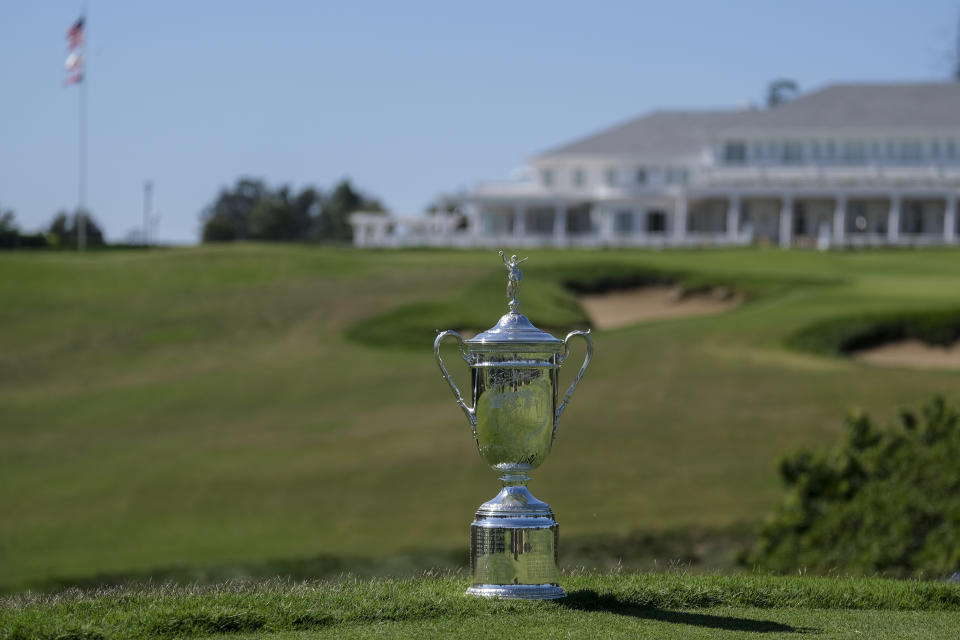 FILE - A U.S. Open Championship trophy is displayed at the ninth hole at Los Angeles Country Club on Sept. 26, 2022, in Los Angeles. The Los Angeles Country Club is opening itself to the world's largest golf audiences with the arrival of the 123rd U.S. Open next week. For its first century of existence, the club and its two courses were rarely seen by anyone except its wealthy members. (AP Photo/Ringo H.W. Chiu, File)