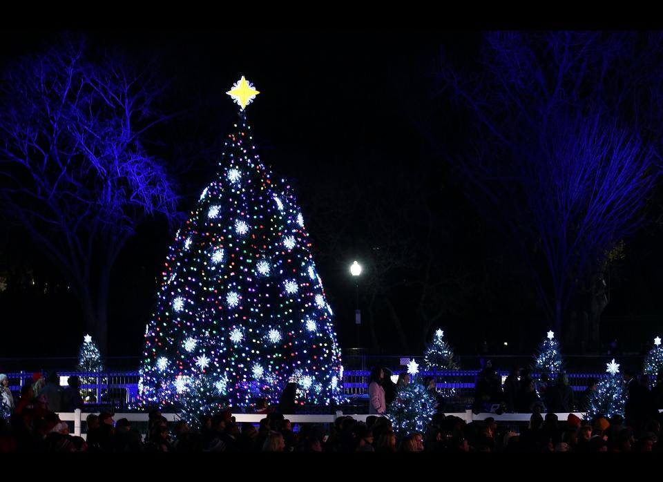 People gather around the National Christmas Tree after it was was lit during its lighting ceremony on December 1, 2011 at the Ellipse, south of the White House, in Washington, D.C. The first family participated in the 89th annual National Christmas Tree Lighting Ceremony. (Photo by Mark Wilson/Getty Images)  