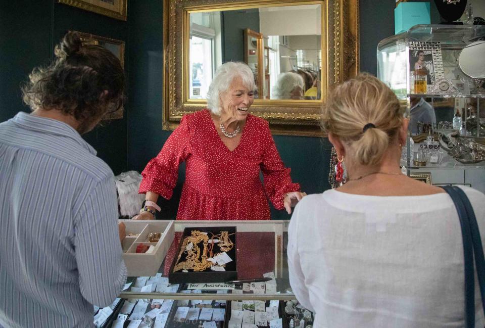 Janet Reynolds, center, helps shoppers look for jewelry Monday inside the Church Mouse.