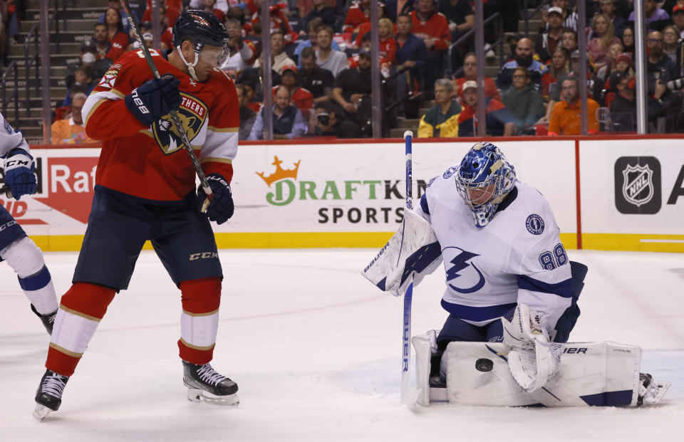 Florida Panthers right wing Patric Hornqvist (70) watches as Tampa Bay Lightning goaltender Andrei Vasilevskiy (88) deflects the puck during the second period of Game 1 of an NHL hockey second-round playoff series Tuesday, May 17, 2022, in Sunrise, Fla. (AP Photo/Reinhold Matay)