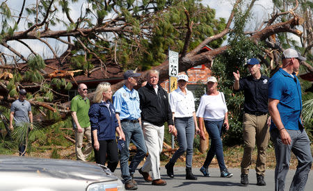 U.S. President Donald Trump and first lady Melania Trump walk down a street with Department of Homeland Security Secretary Kirstjen Nielsen, Folrida Governor Rick Scott and FEMA Director Brock Long in the town of Lynn Haven, Florida, as they tour areas ravaged by Hurricane Michael in Florida and Georgia, U.S., October 15, 2018. REUTERS/Kevin Lamarque