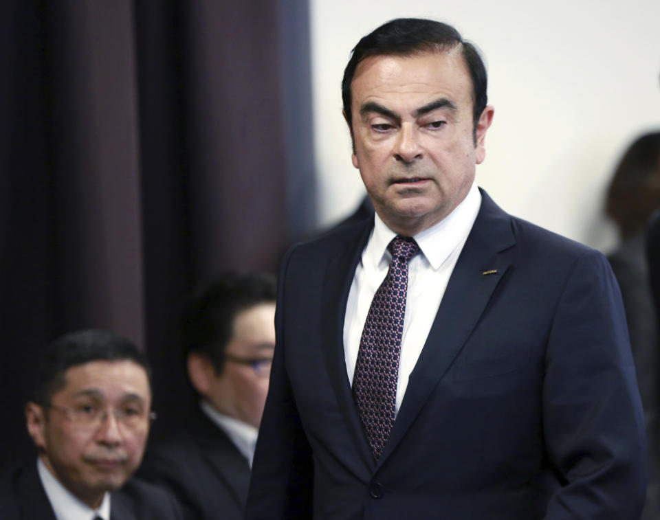 FILE - In this May 12, 2016, file photo, then Nissan Motor Co. President and CEO Carlos Ghosn arrives for a joint press conference with Mitsubishi Motors Corp. in Yokohama, near Tokyo. At left is Nissan Chief Executive Hiroto Saikawa. Nissan’s board is meeting to pick a chairman to replace Carlos Ghosn, arrested last month on charges of violating financial regulations. The Dec. 17, 2018, meeting comes amid an unfolding scandal that threatens the Japanese automaker’s two-decade alliance with Renault SA of France and its global brand, as well as highlighting shoddy governance. (AP Photo/Eugene Hoshiko, File)