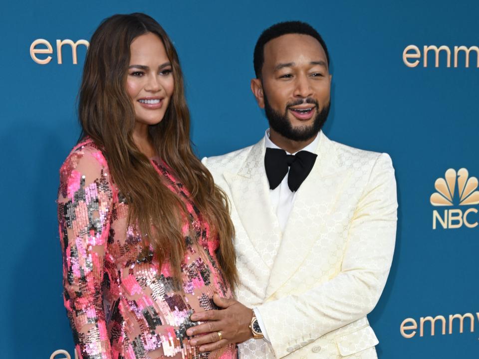 John Legend(R) and Chrissy Teigen arrive for the 74th Emmy Awards at the Microsoft Theater in Los Angeles, California, on September 12, 2022