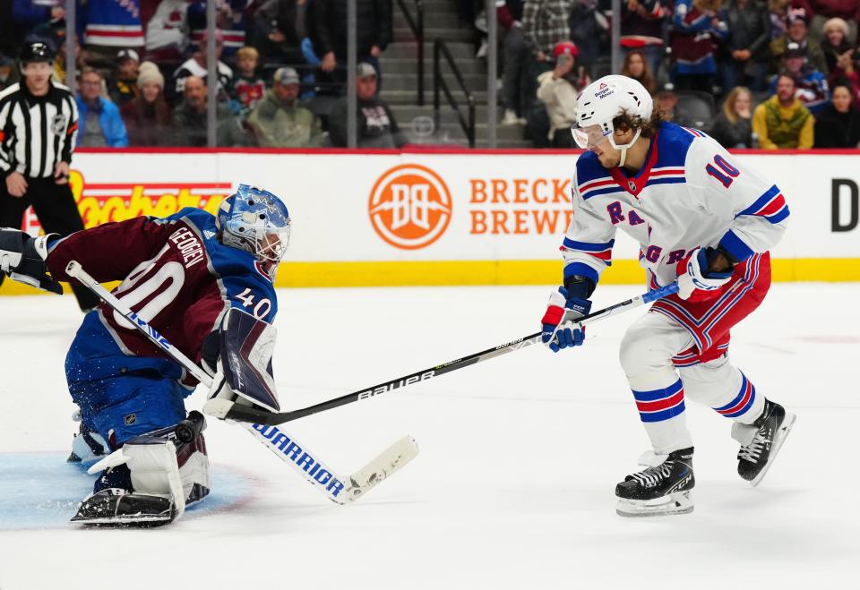 Dec 9, 2022; Denver, Colorado, USA; New York Rangers left wing Artemi Panarin (10) scores on Colorado Avalanche goaltender Alexandar Georgiev (40) in a shoot out period at Ball Arena. Mandatory Credit: Ron Chenoy-USA TODAY Sports