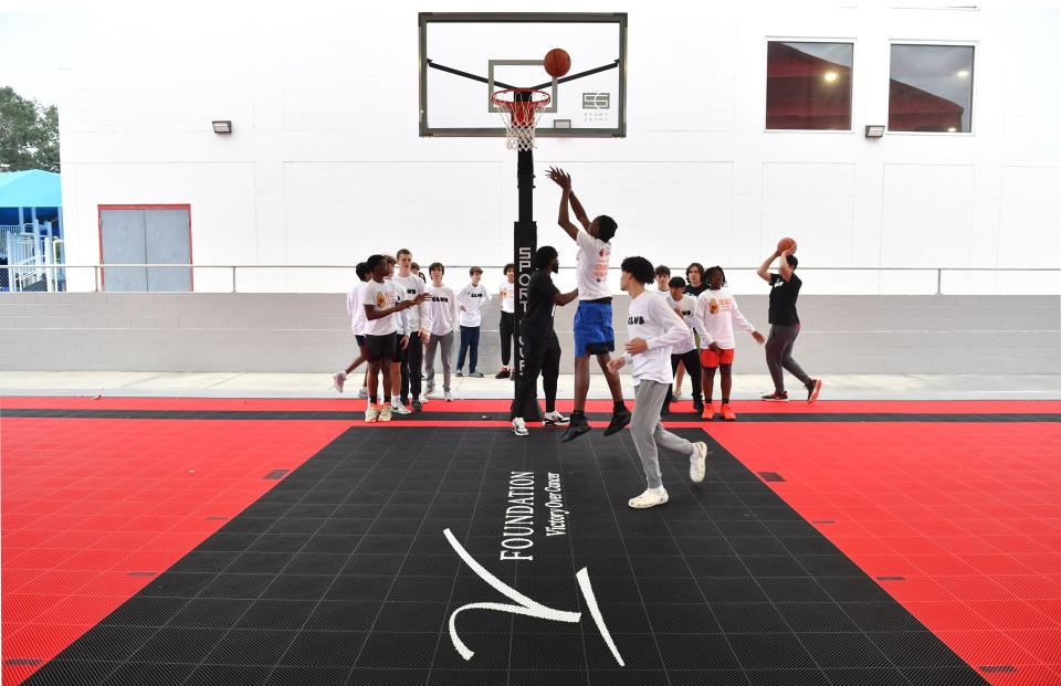Basketball players check out the new Dick Vitale Dream Court at the Sarasota Boys & Girls Club following a ceremony Thursday to dedicate the court in Dick Vitale's name.