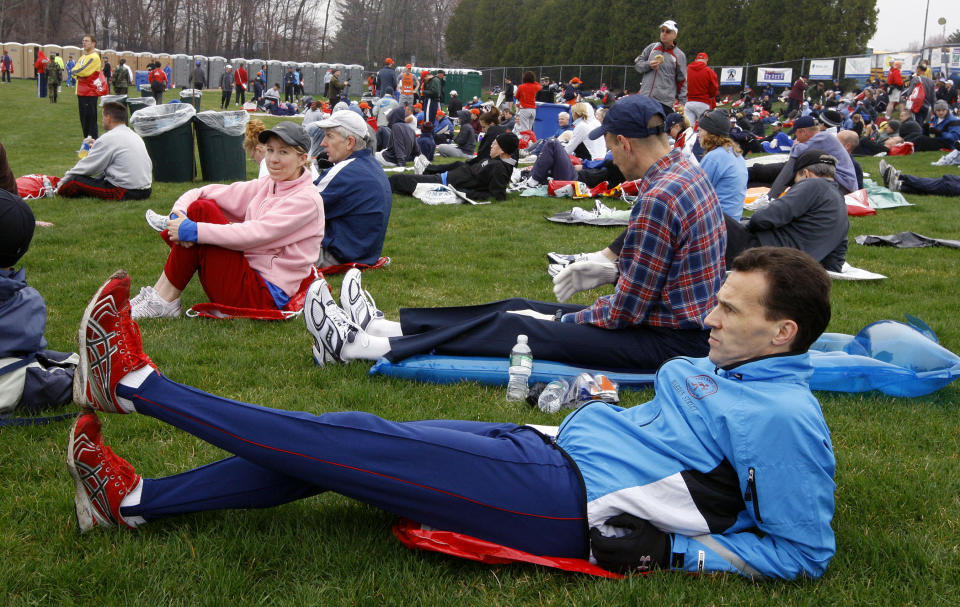 FILE - In this April 21, 2008, file photo, Paul Thompson of Kettering, England, stretches in the Athlete's Village prior to the start of the 112th Boston Marathon in Hopkinton, Mass. Organizers of the marathon, postponed indefinitely because of the coronavirus pandemic, have launched a virtual Athletes' Village in 2020 to reproduce at least some of the camaraderie of the real thing. (AP Photo/Bizuayehu Tesfaye, File)