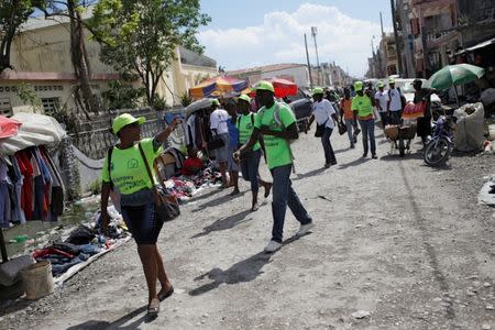 Members of a vaccination campaign against cholera walk in the street to offer vaccines to residents in Les Cayes, Haiti, November 8, 2016. REUTERS/Andres Martinez Casares
