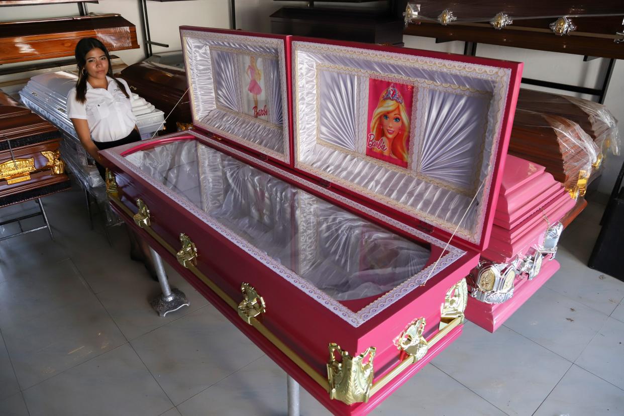 Pink colored coffins featuring a Barbie motif are displayed at a funeral home in Ahuachapan, El Salvador, Friday, Aug. 4, 2023. According to the funeral home manager, the idea was well received as a joyful atmosphere to the loss of a loved one. (AP Photo/Salvador Melendez)