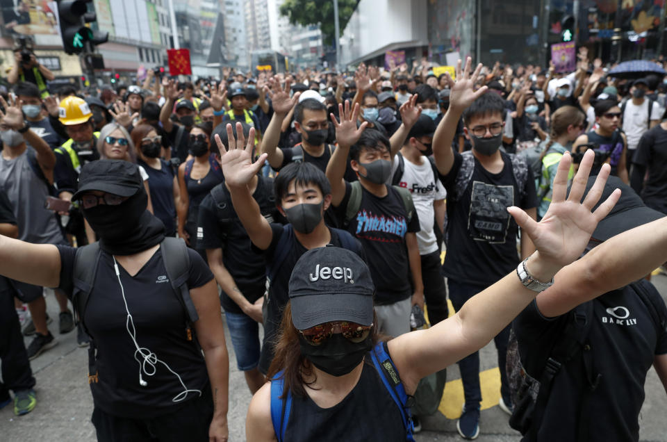 Protestors shout slogans in Hong Kong, Sunday, Sept. 29, 2019. Protesters and police clashed in Hong Kong for a second straight day on Sunday, throwing the city's business and shopping belt into chaos and sparking fears of more ugly scenes leading up to China's National Day this week. (AP Photo/Gemunu Amarasinghe)