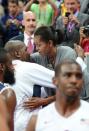 US First Lady Michelle Obama congratulates the US basketball players after they won 98-71 the Men's Preliminary Round Group A match United States vs France at the London 2012 Olympic Games in London