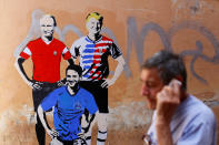 <p>A man walks past a mural signed by “TV Boy” and depicting Russian President Vladimir Putin, U.S. President Donald Trump and Italian Prime Minister Giuseppe Conte as soccer players in downtown Rome, Italy June 15, 2018. (Photo: Tony Gentile/Reuters) </p>