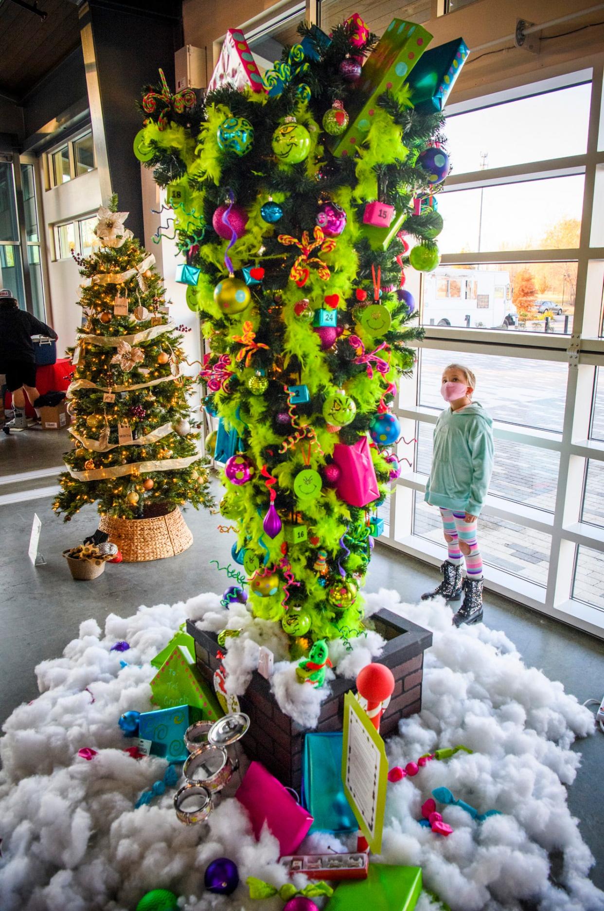Nora Walker looks at the "You're a Mean One, Mr. Grinch" tree donated by TASUS Corp. at the Hope for the Holidays Tree Extravaganza & Auction benefitting New Hope For Families at the Switchyard Park Pavilion on Nov. 18.