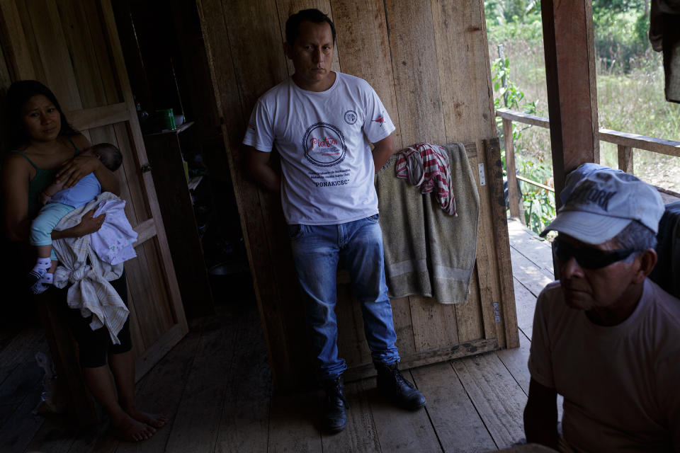 From left: María, daughter of Clemente Grefa; Darling Kaniras, a well-known activist in the community; and Clemente Grefa, pictured in Clemente’s home next to the Piatúa River.<span class="copyright">Andrés Yépez for TIME</span>