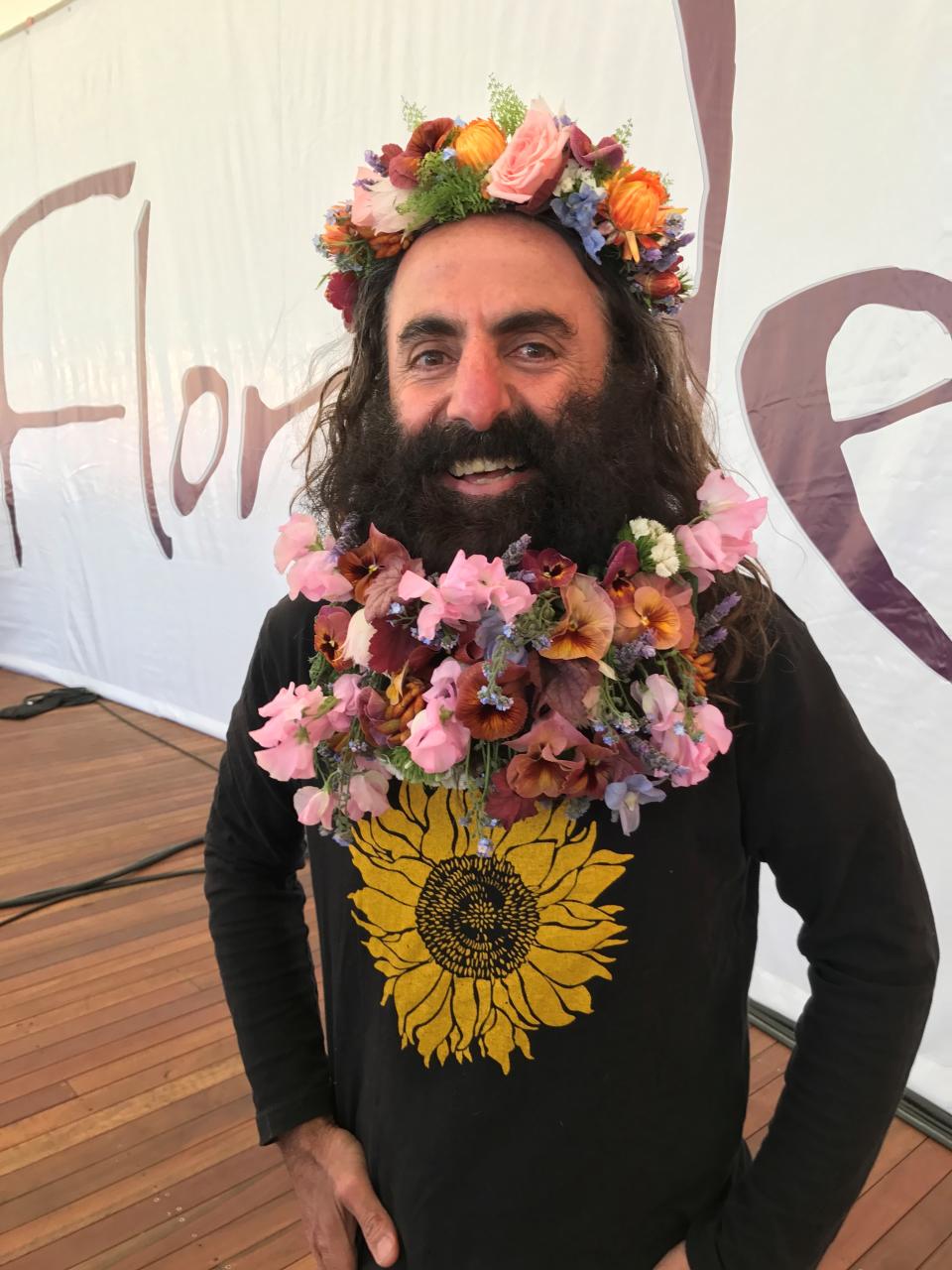 Costa Georgiadis pictured with his beard woven with flowers