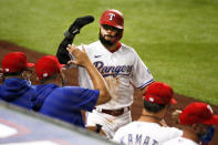 Texas Rangers' Isiah Kiner-Falefa salutes the dugout after scoring on a single by Nick Solak in the third inning of a baseball game against the Seattle Mariners in Arlington, Texas, Tuesday, Aug. 11, 2020. (AP Photo/Ray Carlin)