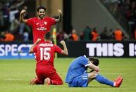 Football - Dnipro Dnipropetrovsk v Sevilla - UEFA Europa League Final - National Stadium, Warsaw, Poland - 27/5/15 Dnipro's Yevhen Seleznyov looks dejected after the game as Sevilla's Benoit Tremoulinas and Timothee Kolodziejczak celebrate winning the UEFA Europa League Final Reuters / Stefan Wermuth