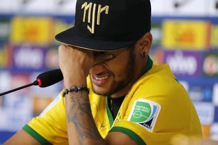 Injured Brazilian national soccer team player Neymar cries during a news conference in Teresopolis, near Rio de Janeiro, July 10, 2014. REUTERS/Marcelo Regua