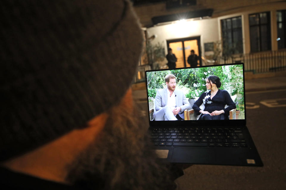 A man watches the Duke and Duchess of Sussex interview with Oprah Winfrey, which is being shown on ITV, on a laptop outside King Edward VII's Hospital, London where the Duke of Edinburgh has been moved to for continuing treatment after his heart surgery at St Bartholomew's Hospital. Picture date: Monday March 8, 2021. (Photo by Yui Mok/PA Images via Getty Images)