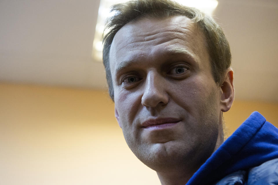 Russian opposition activist Alexei Navalny stands in a court room as he waits for a session in Moscow, Russia, Monday, Sept. 24, 2018. Navalny was released from jail on Monday at the end of a 30-day sentence for staging an unsanctioned protest — and then immediately detained again on staging another past protest. (AP Photo/Dmitry Serebryakov)