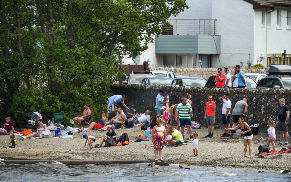 Members of the public sunning themselves at Loch Lomond at the weekend - Getty Images Europe