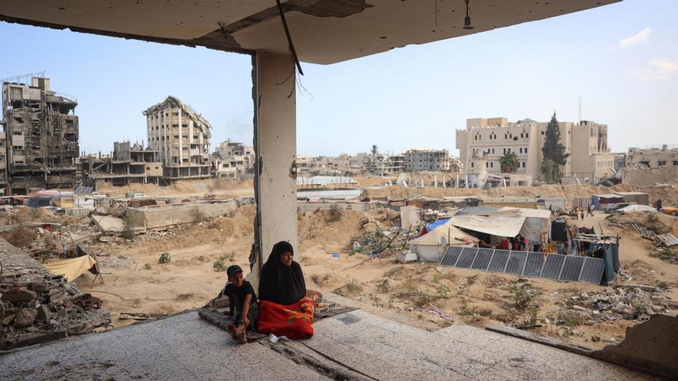 PHOTO: A Palestinian family sits in the remains of their home damaged in previous Israeli bombardment, as some residents return to the city of Khan Yunis, in the southern Gaza Strip, June 30, 2024. (Eyad Baba/AFP via Getty Images)