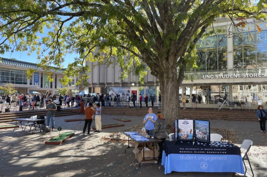 Club leaders at the University of North Carolina at Chapel Hill interact with students outside the student union in a quad known at “The Pit” on Monday, Oct. 24, 2022. (AP Photo/Hannah Schoenbaum, File)