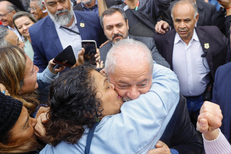 A supporter kisses former Brazilian President Luiz Inacio Lula da Silva, who is running for president again, after he voted in general elections in Sao Paulo, Brazil, Sunday, Oct. 2, 2022. (AP Photo/Marcelo Chello)
