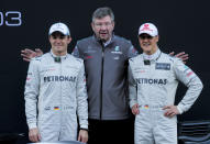 Mercedes team drivers Germans Michael Schumacher (R), Nico Rosberg (L) and team principal Ross Brawn pose after unveiling the W03 2012 car during day one of Formula One winter testing at Catalunya's racetrack in Montmelo, near Barcelona. (AFP)