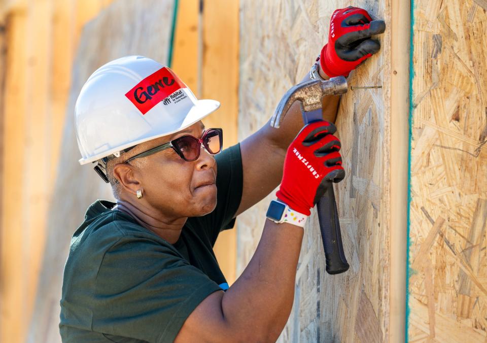 Gerre Currie, vice president and community development officer at Financial Federal Bank and chair of the Memphis Habitat board of directors, helped hang wall panels alongside other volunteers, donors, staff and future Habitat homebuyers in Castalia Heights, Thursday, Aug. 17.
