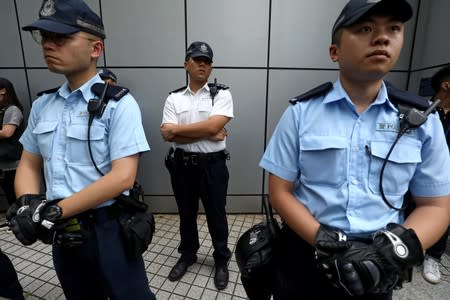 Police officers stand guard in front of a police headquarter in Hong Kong