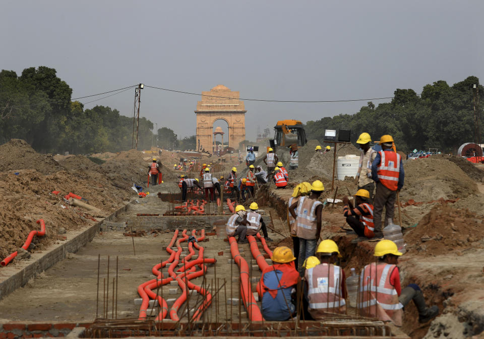 India Gate monument is seen behind as laborers work on the Central Vista project in New Delhi, India, July 16, 2021. On Thursday, Sept. 8, 2022, India’s Prime Minister Narendra Modi urged the country to shed its colonial ties in a ceremony to rename Rajpath, a boulevard that was once called Kingsway after King George V, Modi called it a "symbol of slavery" under the British Raj. (AP Photo/Manish Swarup)