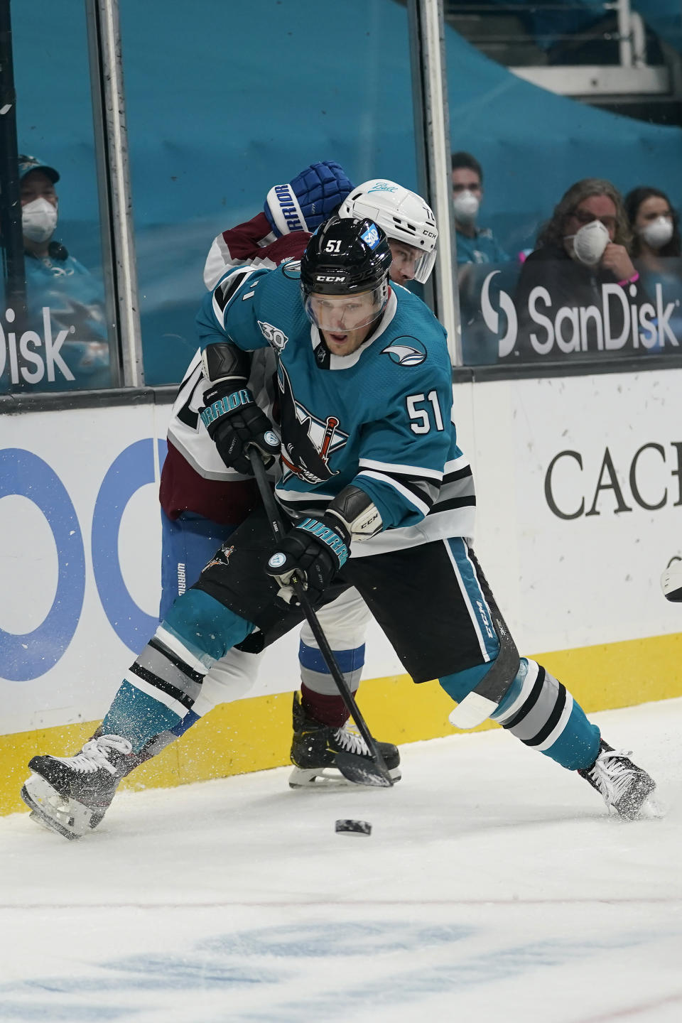 San Jose Sharks defenseman Radim Simek (51) reaches for the puck in front of Colorado Avalanche right wing Joonas Donskoi during the second period of an NHL hockey game in San Jose, Calif., Monday, March 1, 2021. (AP Photo/Jeff Chiu)