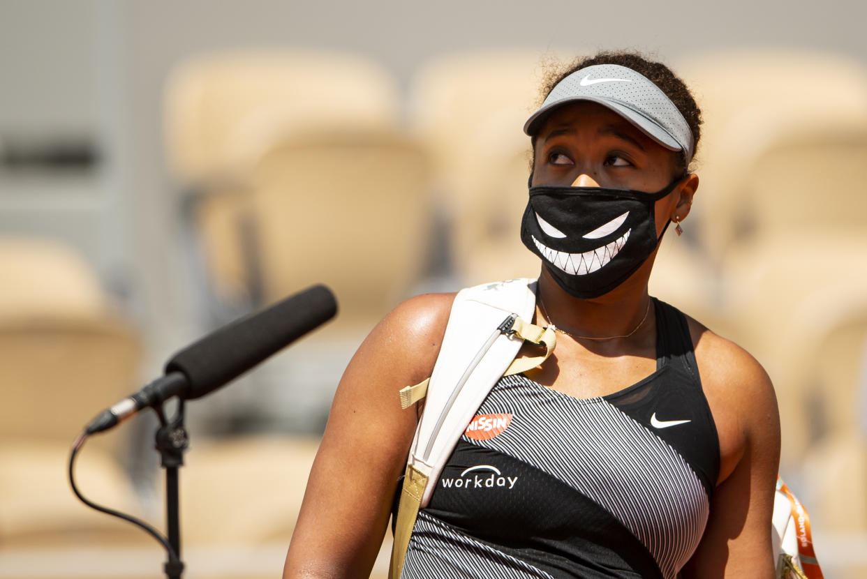 PARIS, FRANCE - MAY 30: Naomi Osaka of Japan is interviewed by Fabrice Santoro of France after her victory over Patricia Maria Țig of Romania in the first round of the women’s singles at Roland Garros on May 30, 2021 in Paris, France.