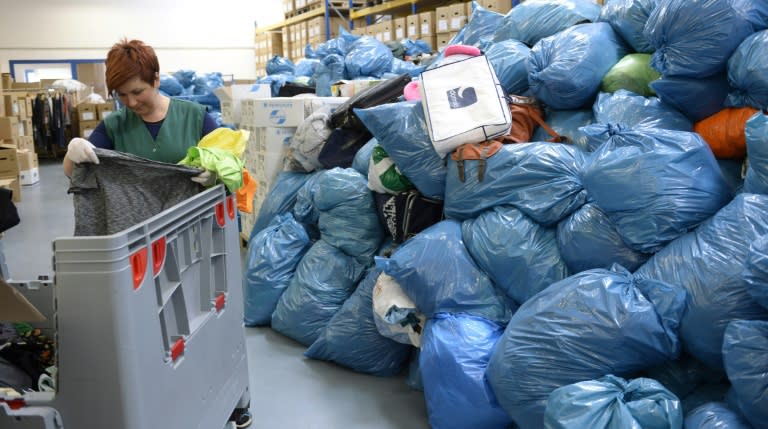 Donations for refugees arriving in Bavaria are piled up at social aid association Diakonia in Munich, southern Germany, on September 4, 2015