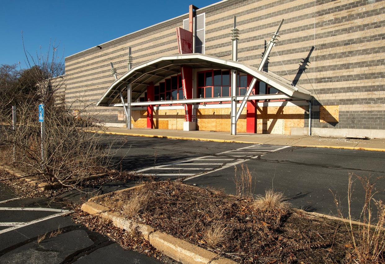 An empty and overgrown parking lot surrounds the former Regal Cinema on Route 9 in Westborough.