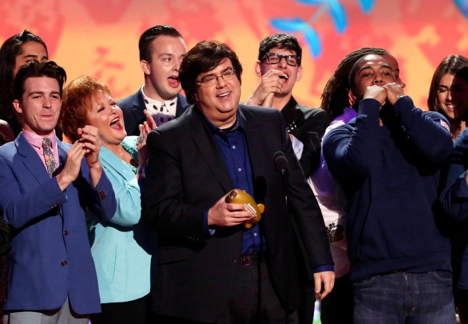 Dan Schneider, center, accepts an award in Los Angeles. He exited Nickelodeon in 2018 after an investigation determined he committed verbal abuse on set (Matt Sayles/Invision/AP, File)