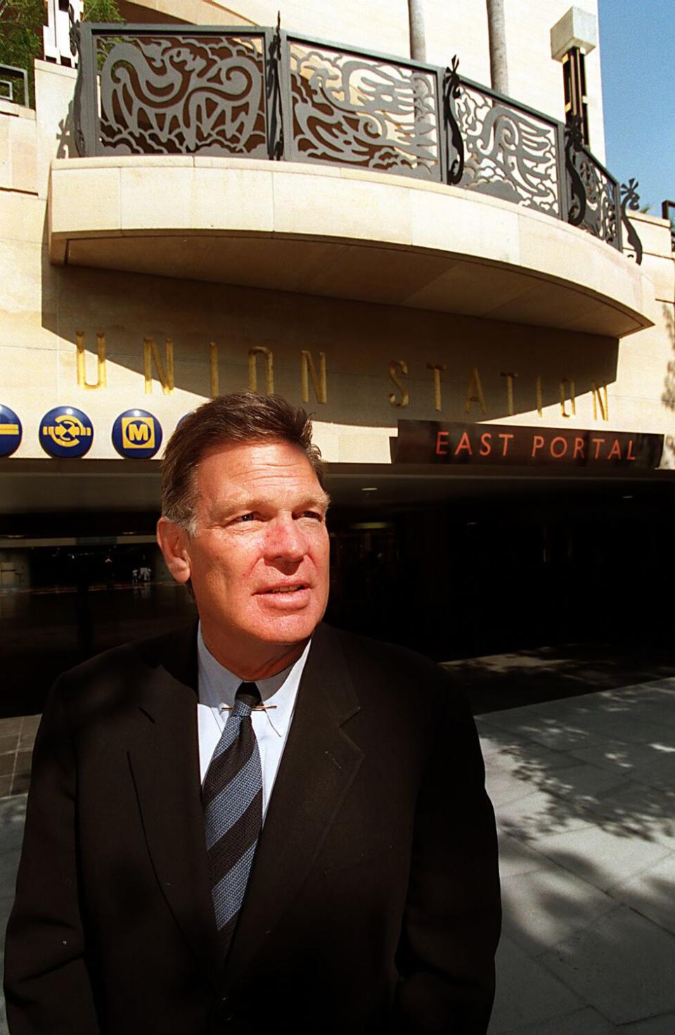 A man in a suit outside a building