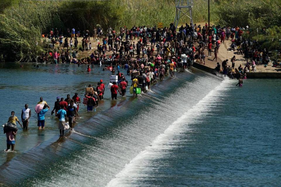 Thousands of Haitian migrants used a dam to cross to and from the United States from Mexico, Friday, Sept. 17, 2021, in Del Rio, Texas.