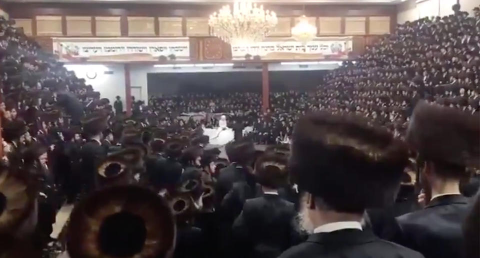 Thousands of people packing a New York synagogue for a wedding during the coronavirus pandemic.
