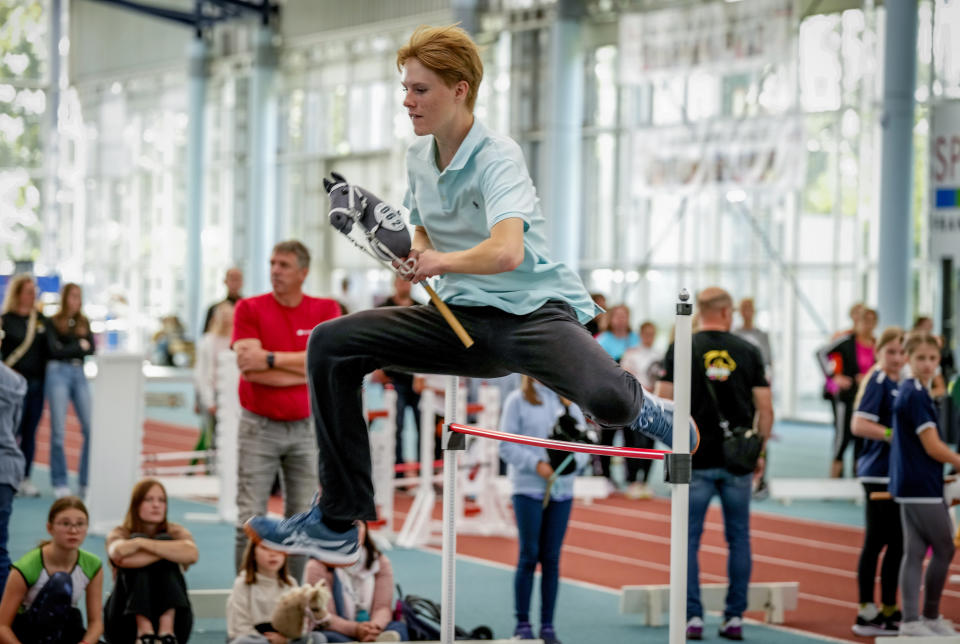 A participant clears the bar during the first German Hobby Horsing Championship in Frankfurt, Germany, Saturday, Sept. 14, 2024. (AP Photo/Michael Probst)