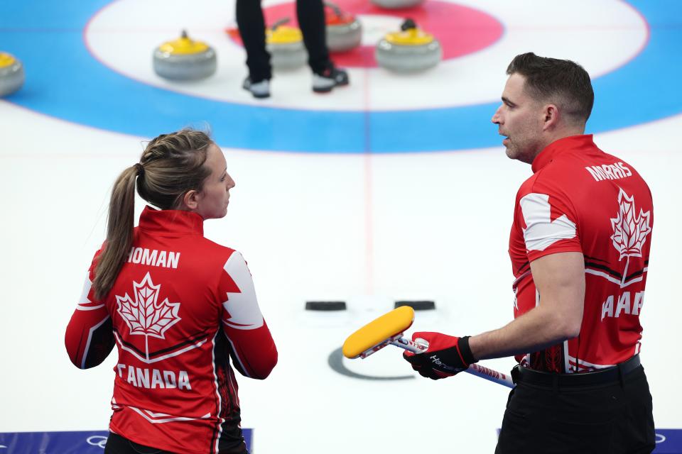 Rachel Homan and John Morris of Team Canada talk during the Curling Mixed Doubles Round Robin against Team Switzerland (Getty Images)