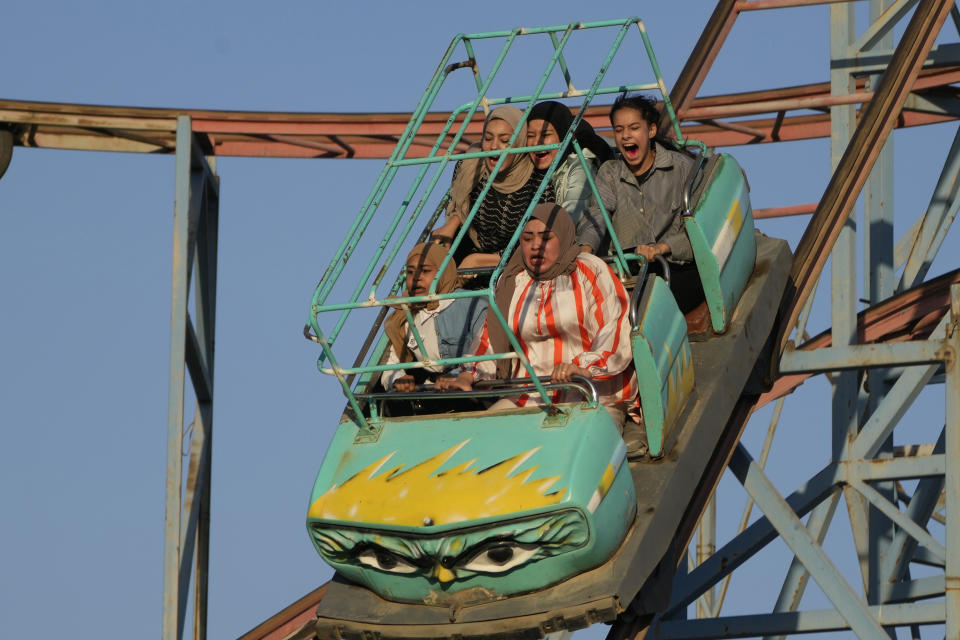 Iraqis enjoy a ride at an amusement park during Eid al-Adha in Baghdad, Iraq, Thursday, June. 29, 2023. Eid al-Adha, or Eid al-Adha, is celebrated to commemorate Prophet Abraham's faith in his willingness to sacrifice his son. (AP Photo/Hadi Mizban)
