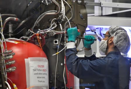 SpaceX technicians work on the next Crew Dragon Demo-2 craft as NASA Administrator Jim Bridenstine tours SpaceX headquarters with NASA astronauts Bob Behnken and Doug Hurley in Hawthorne