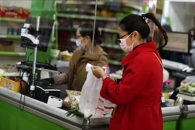 Customers wear face masks in a supermarket in Madrid, Spain