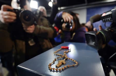 Rosary beads and a poppy are shown at a news conference in Toronto, Ontario, February 24, 2015. REUTERS/Aaron Harris