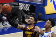 Minnesota's Payton Willis (0) scores past Pittsburgh's William Jeffress during the second half of an NCAA college basketball game Tuesday, Nov. 30, 2021, in Pittsburgh. Minnesota won 54-53. (AP Photo/Keith Srakocic)