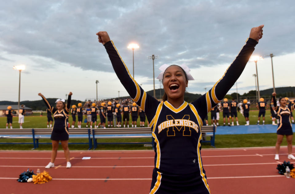 Modern female cheerleaders in skirts